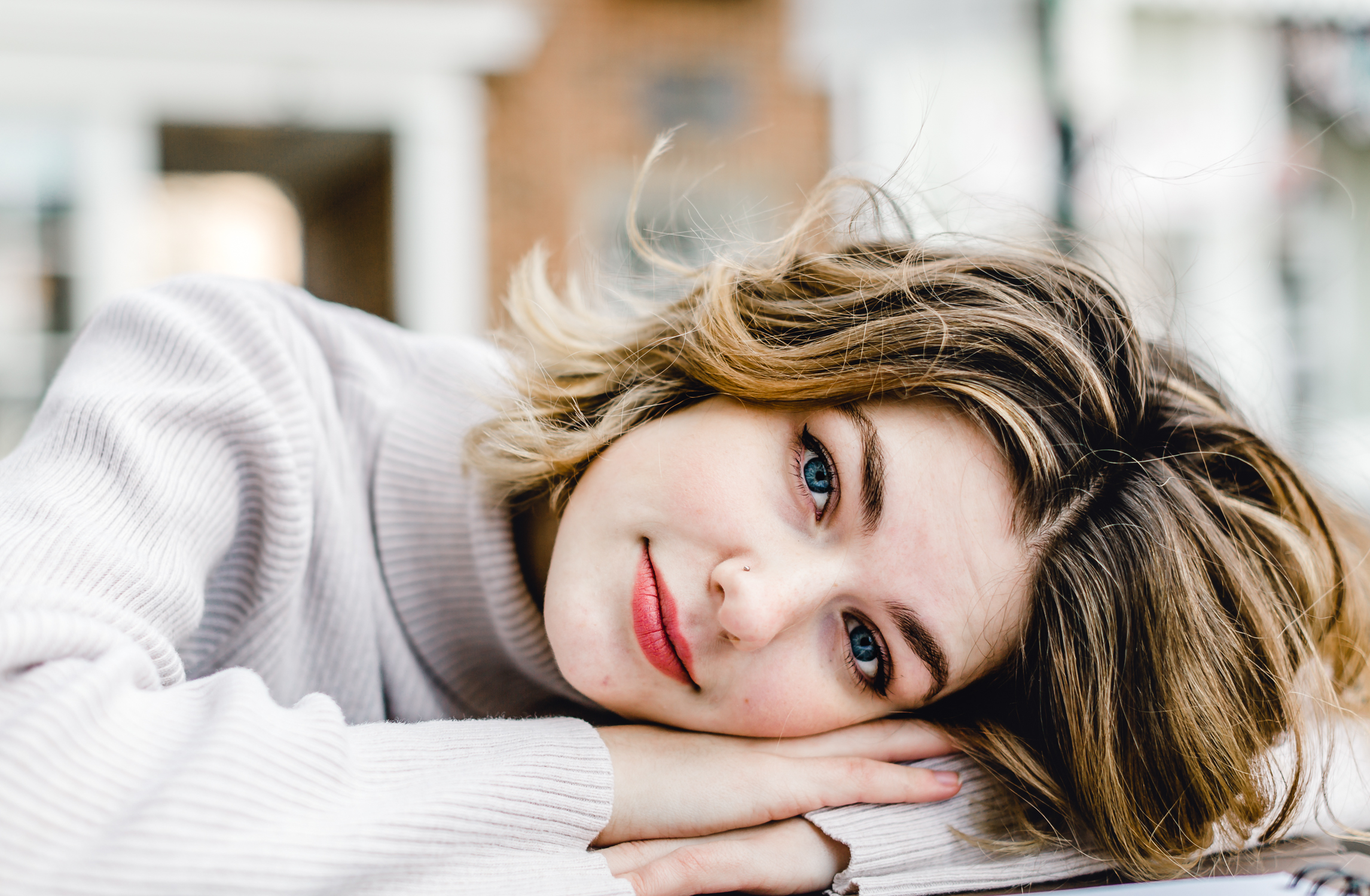 A young woman from Nashville TN, peacefully laying on a table with her eyes closed during a personal branding session.