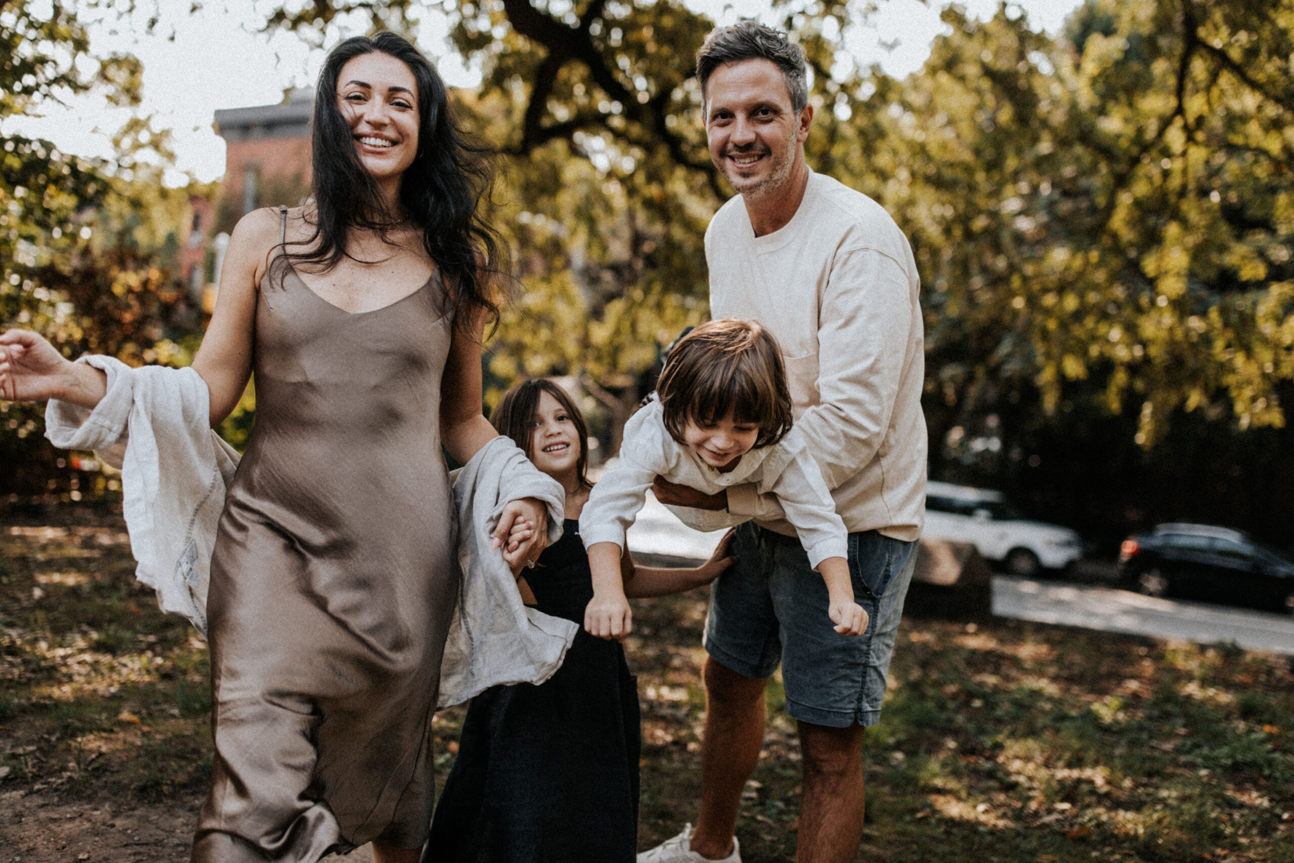 A family is having a photo session in an urban park in Downtown Portland with their children.